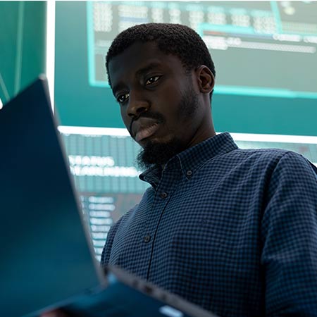African American male looking at laptop