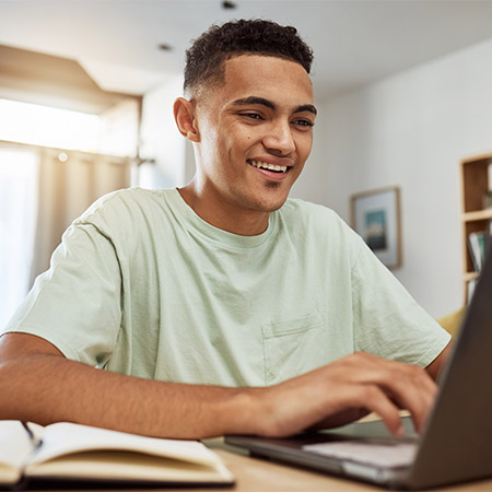 Student researching online college program benefits in a remote learning environment.
