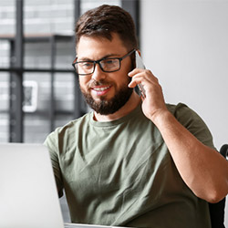 Man on cell phone and laptop